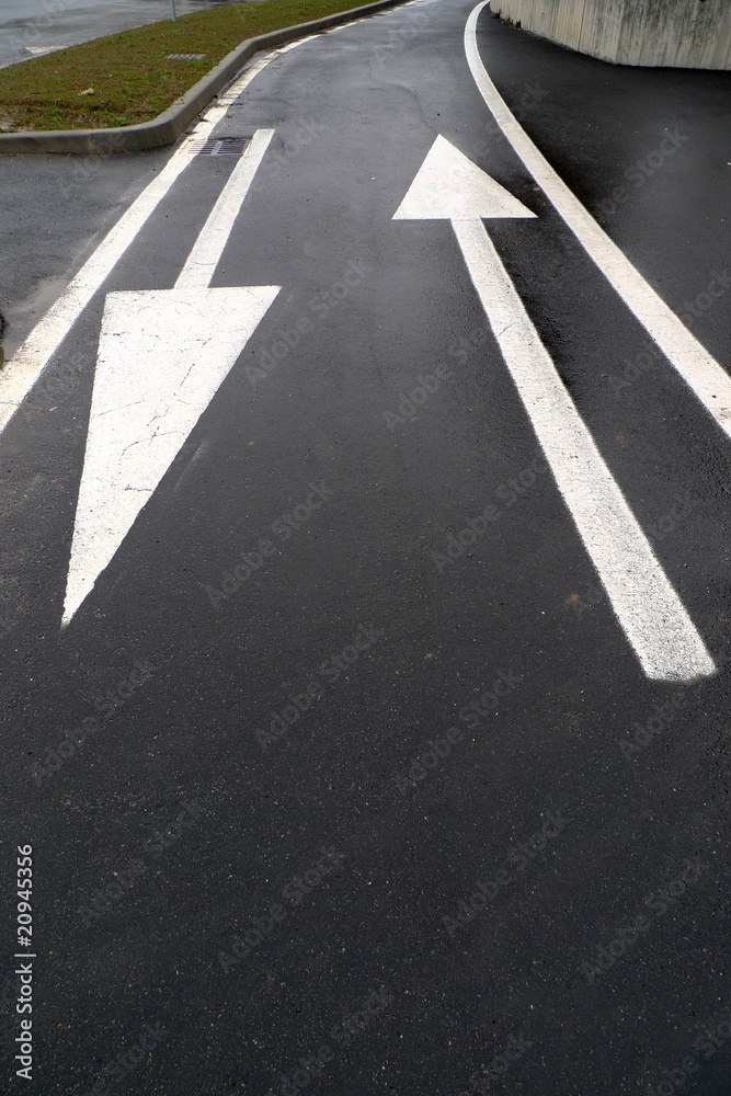  Asphalt road with  two opposite arrows