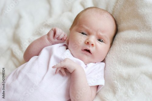 Sweet little newborn baby in a bed