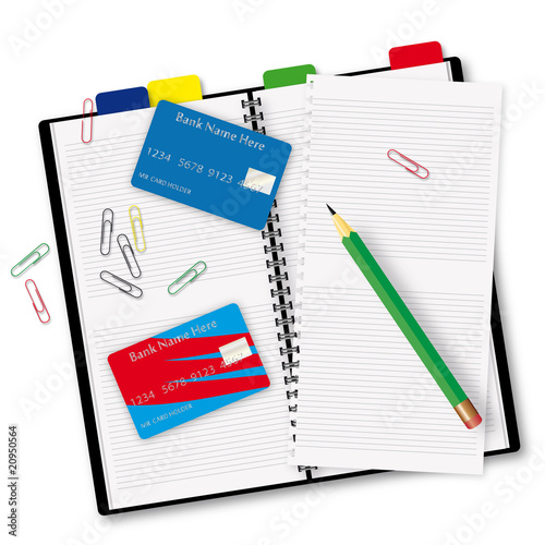 Open copybook with a pair of credit cards