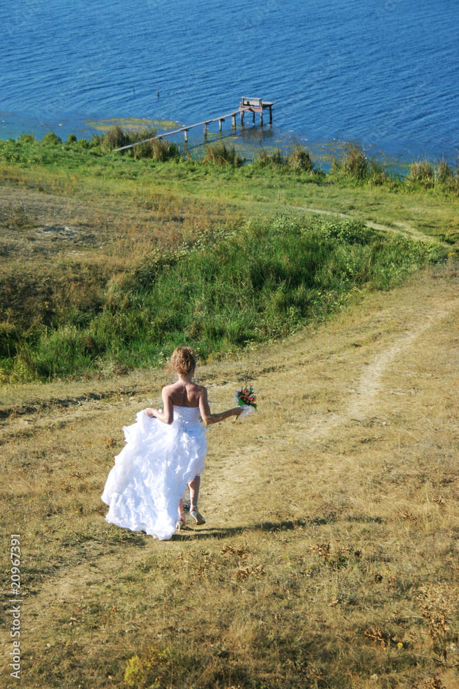 Beautiful bride runs to the river