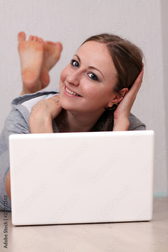 Closeup portrait of a young woman using laptop Closeup portrait of a young woman using laptop
