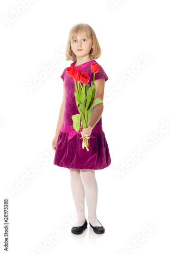 Cute girl giving a bouquet of tulips isolated on white, focus on
