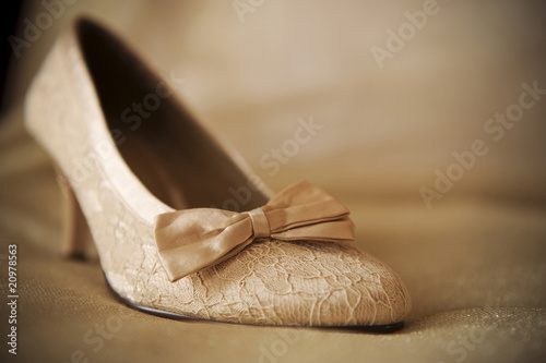 beige wedding shoe with lint on beige material
