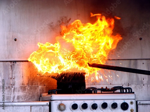 Putting water  on oil fire demonstration