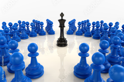 Black chess king surrounded by blue pawns