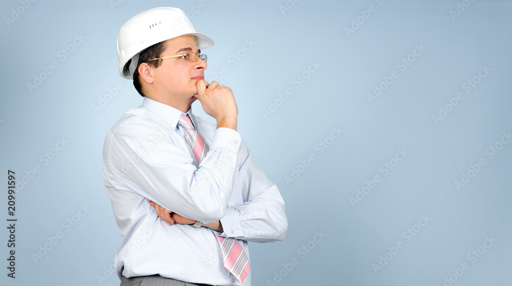 engineer with white hard hat on grey background engineer with white hard hat on grey background