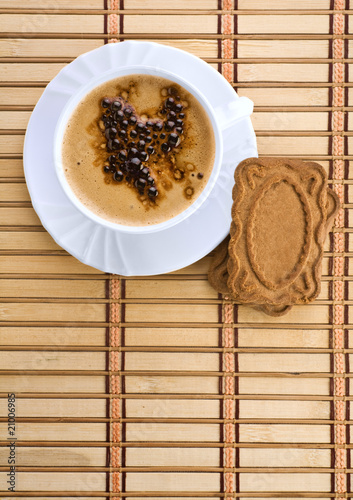 blue mug with espresso coffee with Cookies on a wum mat photo