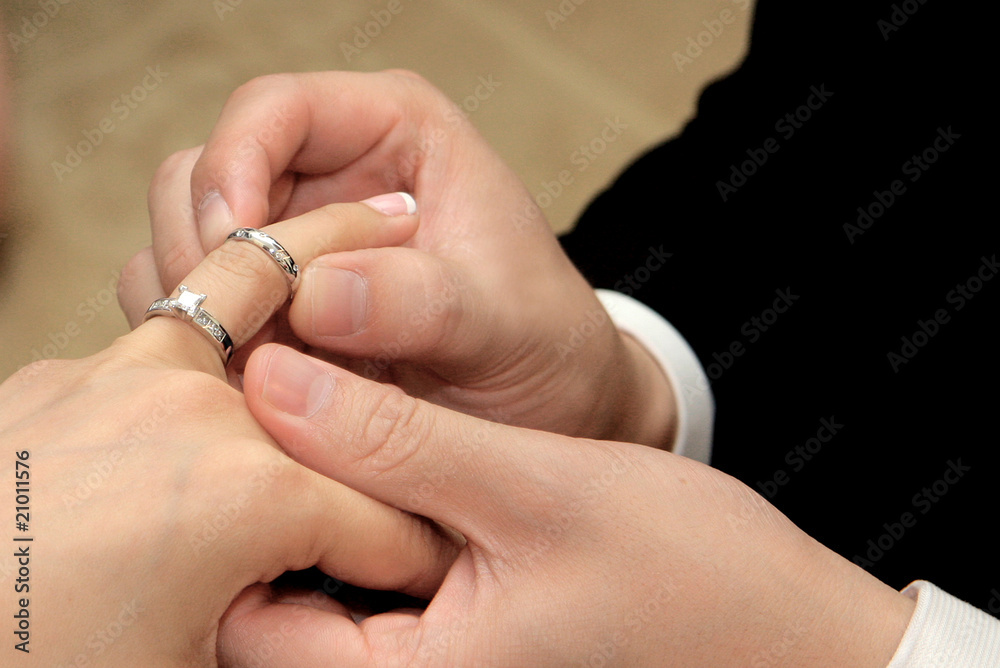 Groom giving an engagement ring to his bride Groom giving an engagement ring to his bride