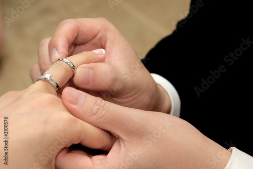 Groom giving an engagement ring to his bride