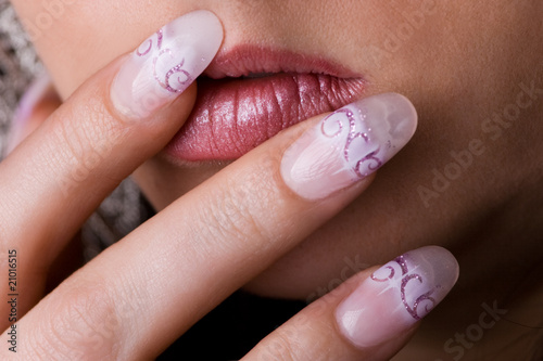 Women fingers with long acrylic fingernail