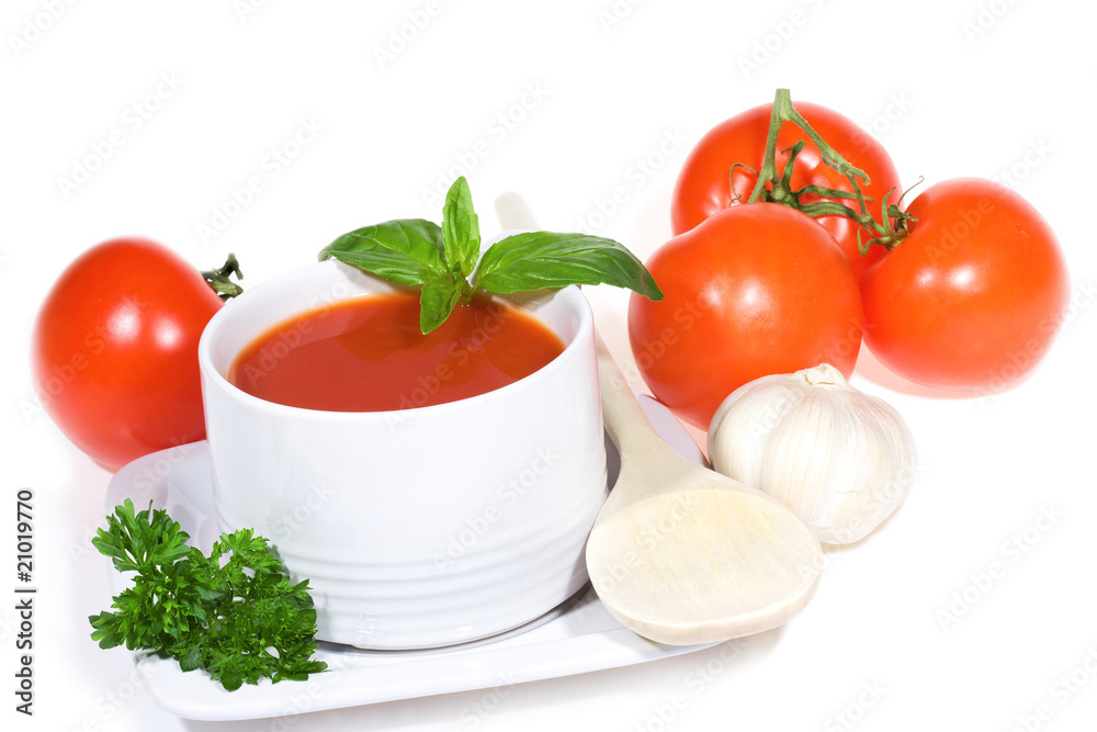 tomato soup with basil leaves and vegetables