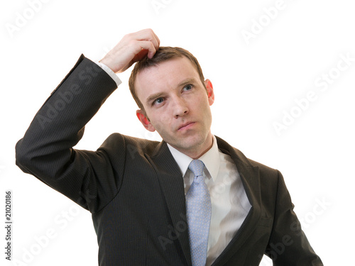 businessman scratching his head on white background