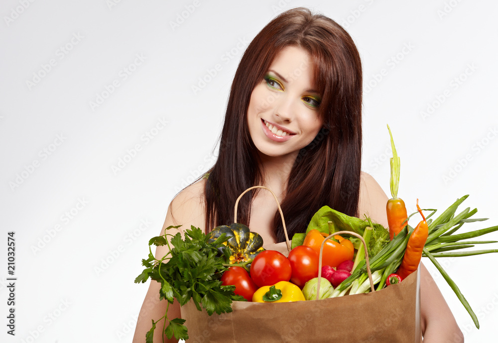 Smiling woman with fruits and vegetables. Over white background Smiling woman with fruits and vegetables. Over white background