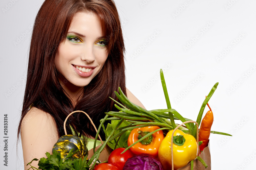 Smiling woman with fruits and vegetables. Over white background Smiling woman with fruits and vegetables. Over white background
