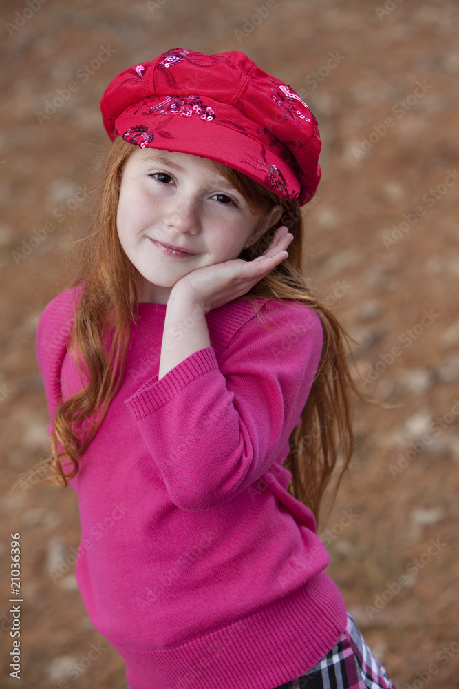 Beautiful little redheaded girl outdoors in red hat Beautiful little redheaded girl outdoors in red hat