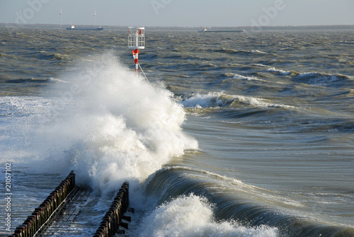 Bild auf Leinwand Violent waves flooding a pier during a storm