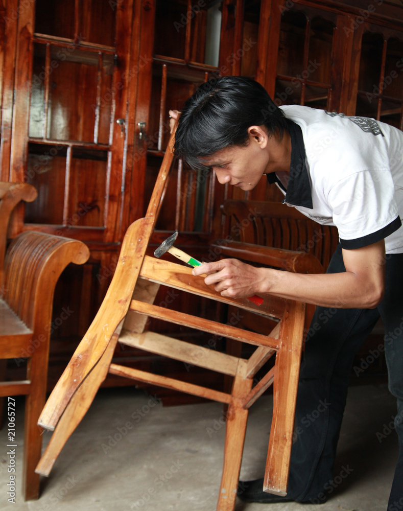 Portrait of man working on furniture