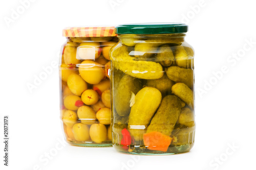Pickled cucumbers and olives in glass jar