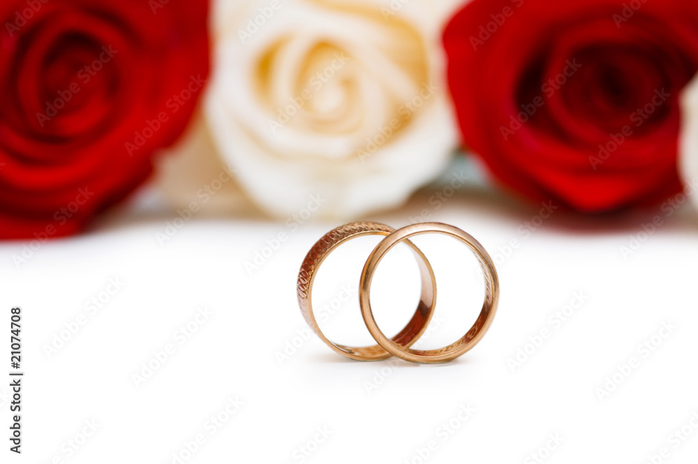 Wedding concept with roses and golden rings Wedding concept with roses and golden rings