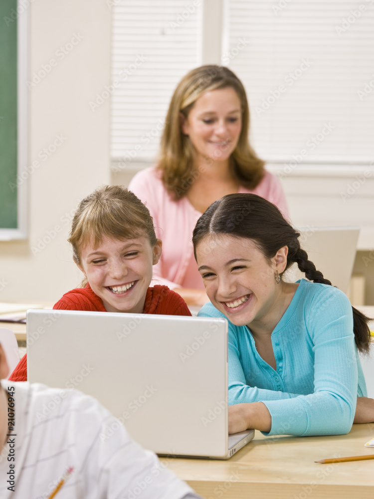 Girls using laptop in classroom Girls using laptop in classroom