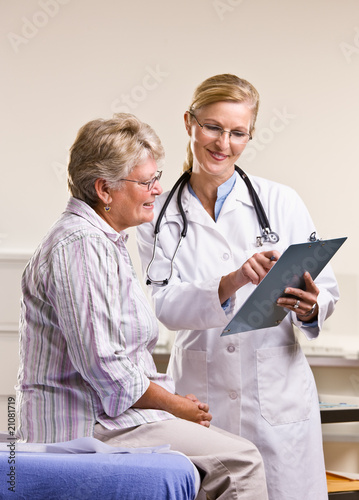 Doctor explaining medical chart to senior woman