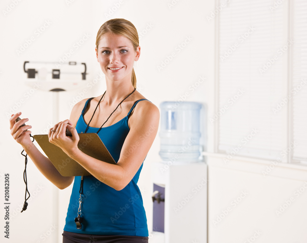 Woman holding stopwatch and clipboard Woman holding stopwatch and clipboard