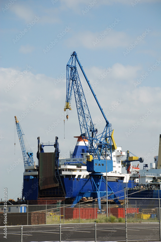 Ships in dock and crane on a wharf