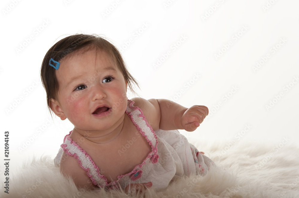 Pacific Islander baby girl smiling whilte learning to crawl Pacific Islander baby girl smiling whilte learning to crawl