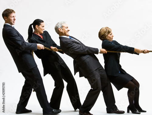Business people playing tug-of-war