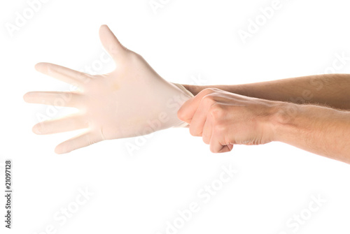 Hands of person putting on a medical glove isolated on white © Vladyslav Bashutskyy