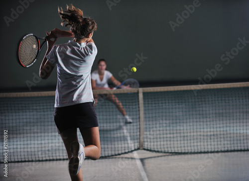 young girls playing tennis game indoor © .shock
