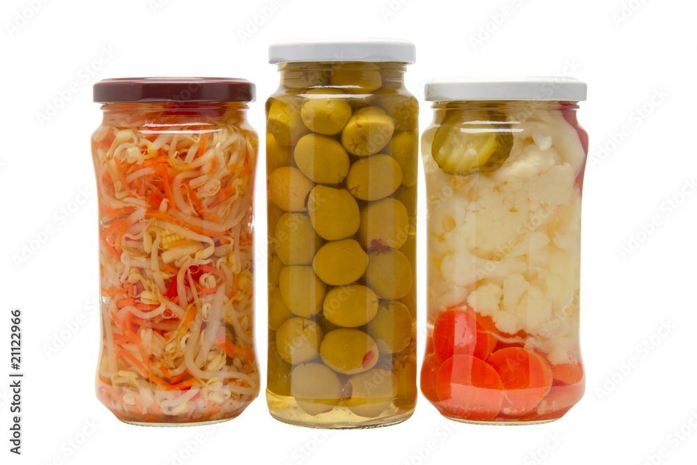 Glass jars with marinated vegetables isolated on the white back Glass jars with marinated vegetables isolated on the white back