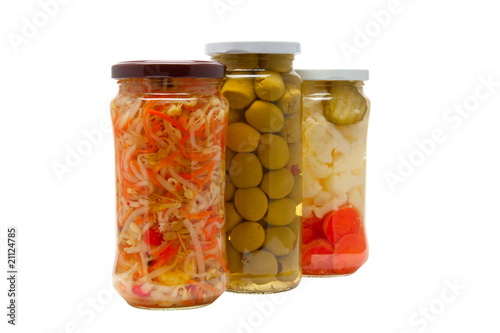 Glass jars with marinated vegetables  isolated on the white back
