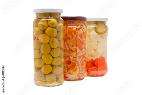 Glass jars with marinated vegetables  isolated on the white back