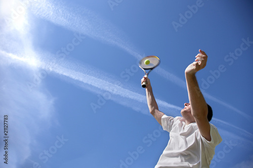 Tennis player with blue sky background © Anna Jurkovska