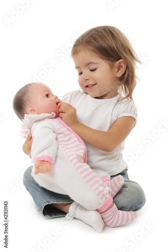 cute little girl playing with her doll