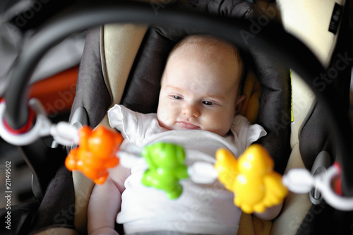 Little baby playing in a carseat