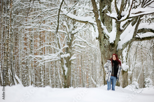 Young woman and snowy forest