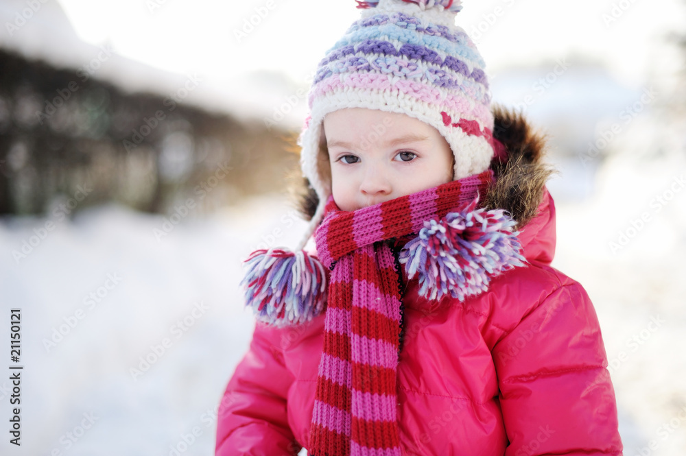 Little girl walking in a purple wintercoat Little girl walking in a purple wintercoat