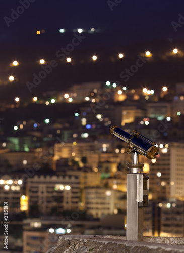 night city (with a telescope in the foreground, focus is on the