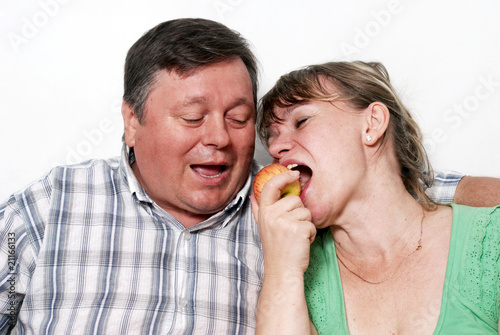 Happy seniors couple with apple