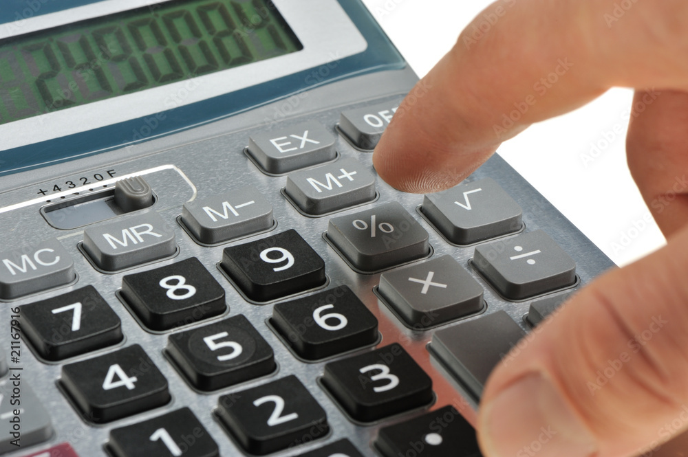 The calculator and a hand of the man The calculator and a hand of the man