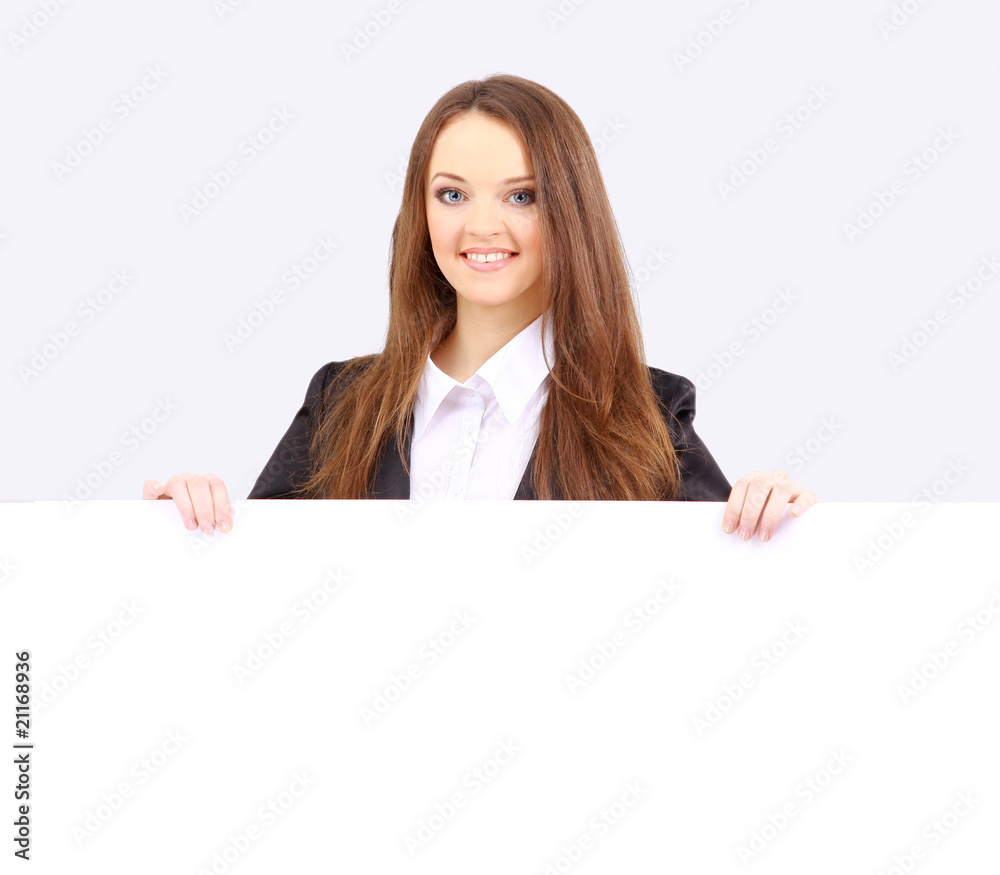 Isolate of a business woman standing beside a blank board. Isolate of a business woman standing beside a blank board.