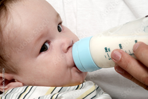 Portrait baby drinking milk of her bottle photo