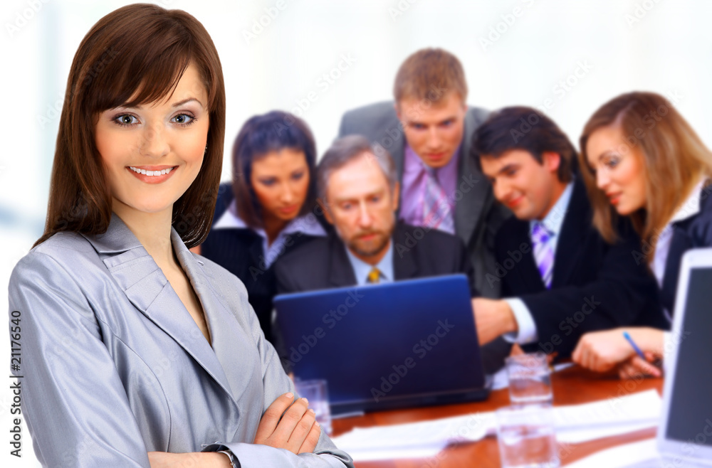 Smiley businesswoman with a group behind him.