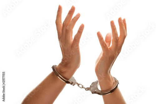 Tableau sur toile Handcuffed Woman Raising Hands in Air on White