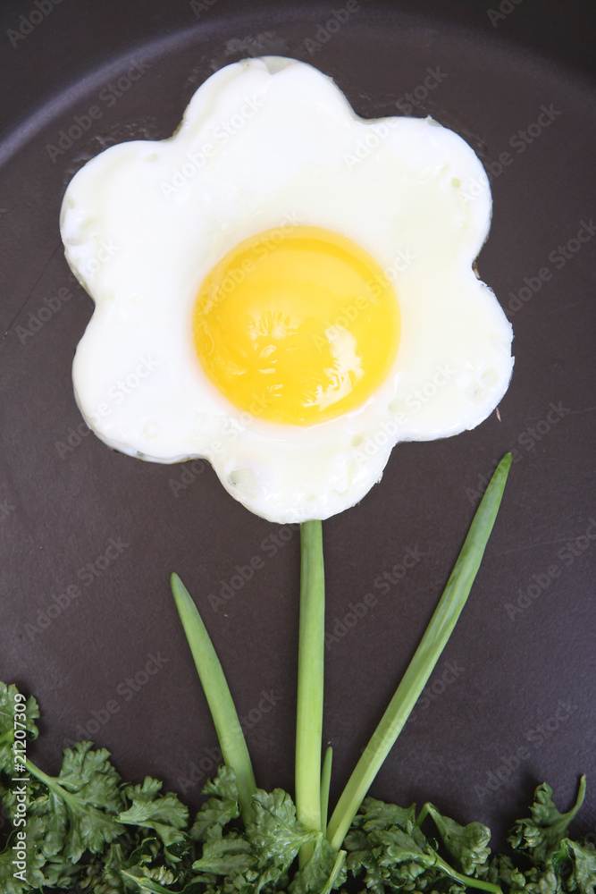 Flower shaped fried egg with greenery