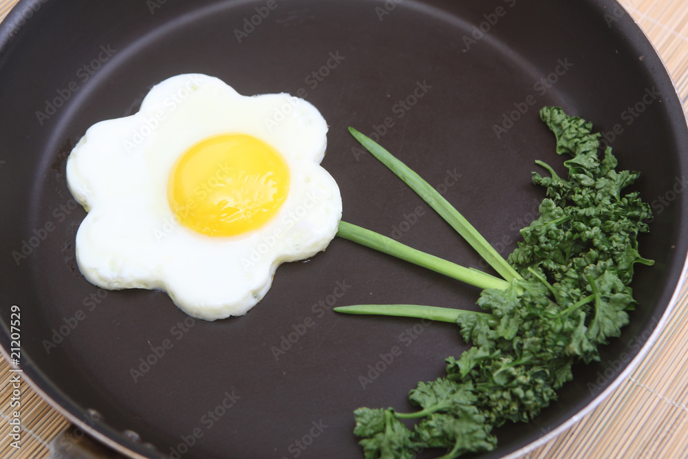 Flower shaped fried egg with greenery