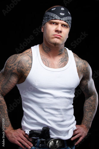 Tattooed gangster with gun photo