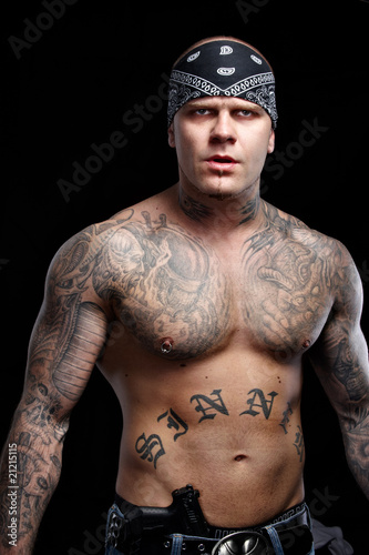 Tattooed gangster with gun